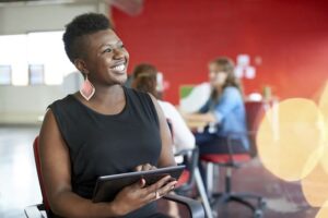 Confident female designer working on a digital tablet in red