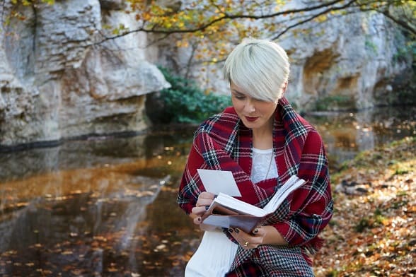 Woman Reading Book near Pond